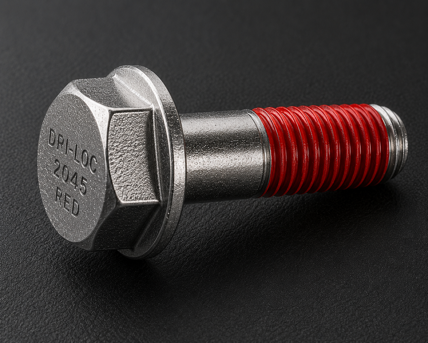 A close-up of a metallic hex bolt with red threadlocker on the threads, placed on a black textured surface. The bolt head is engraved with "DPL-LOC 2045 FED".